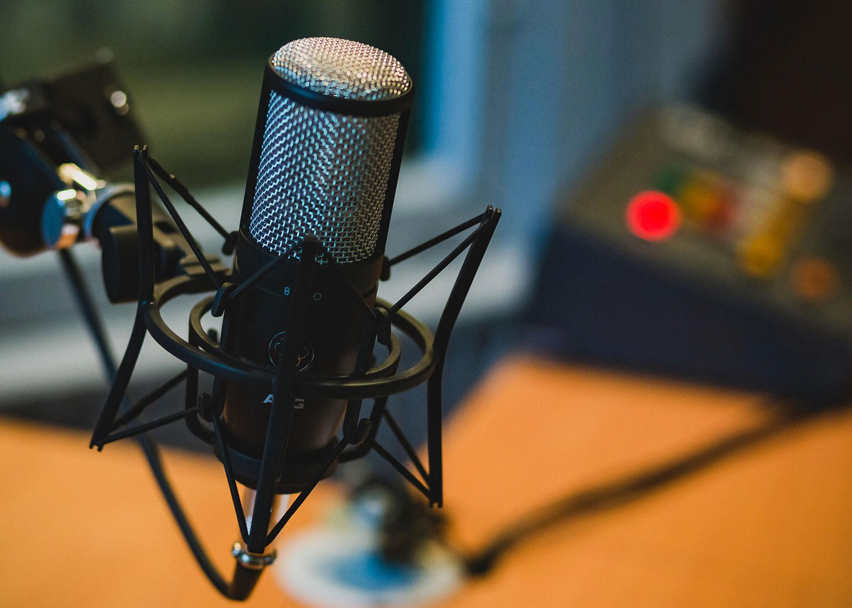 Microphone in studio next to computer monitor