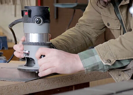 Man sanding instrument in garage